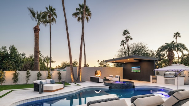 A modern outdoor pool area with lounge chairs, a hot tub, and a barbecue setup. - Scottsdale Retreat Outdoor Oasis w/Heated Pool & Spa, Outdoor Kitchen & 100" TV (Scottsdale)
