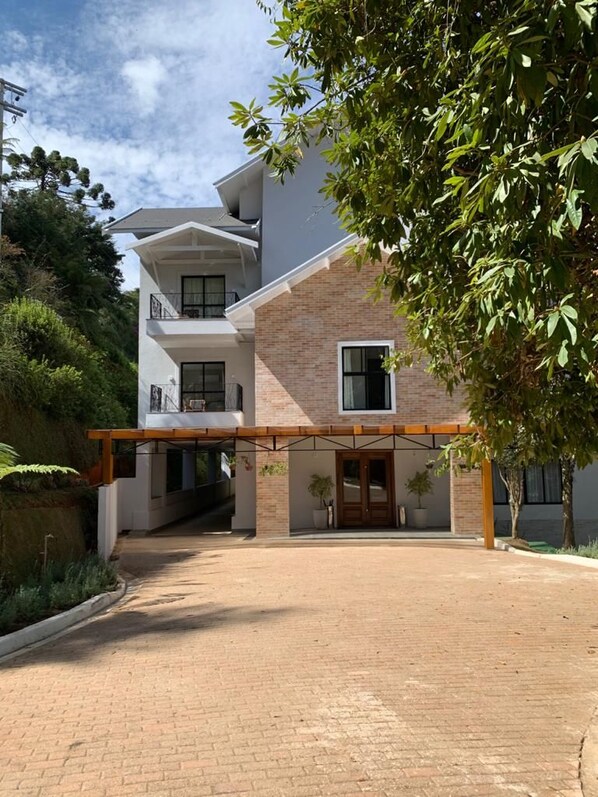A modern two-story building with a covered entrance and a brick facade.