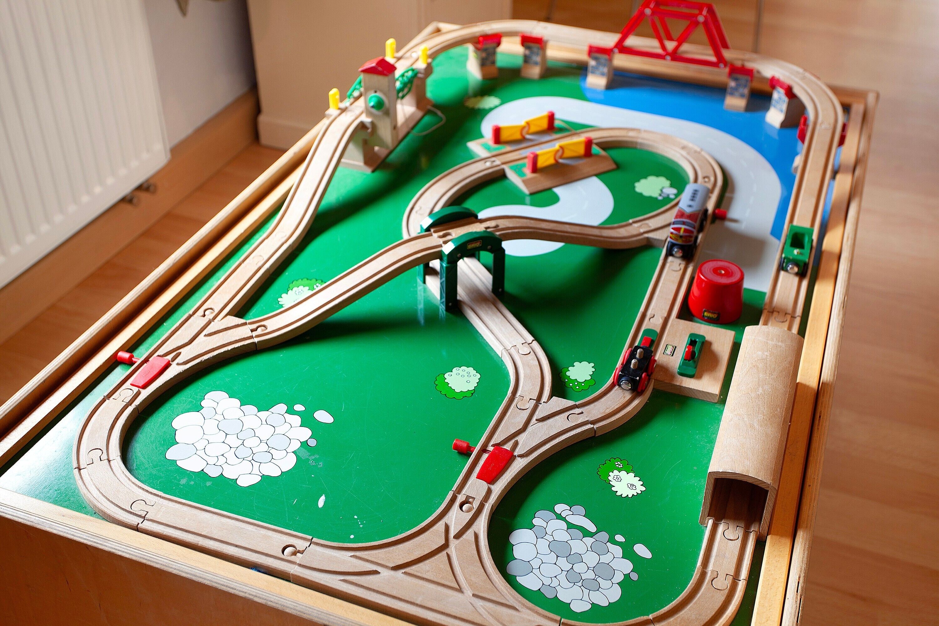 A model train set with tracks, trains, and a bridge.