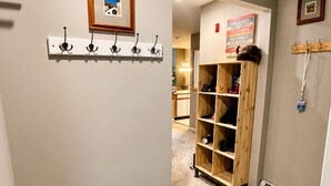 A hallway with a coat rack, a wooden shelf unit, and a radiator. - OKEMO WINTERPLACE Best Location, Ski-In/Ski-Out 4BR/3BATH + LOFT.  Spacious. (Ludlow)