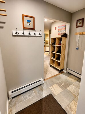 A hallway with a coat rack, a wooden shelf unit, and a radiator. - OKEMO WINTERPLACE Best Location, Ski-In/Ski-Out 4BR/3BATH + LOFT.  Spacious. (Ludlow)