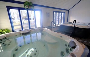 A hot tub with a view of the outside, a window, and a plant. - OKEMO WINTERPLACE Best Location, Ski-In/Ski-Out 4BR/3BATH + LOFT.  Spacious. (Ludlow)