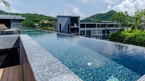 A modern hotel with a pool overlooking a mountainous landscape. - Citygate Kamala Residence P506  (Kamala)