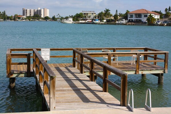A wooden dock with a sign indicating it is private property with no trespassing or fishing allowed.