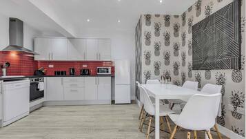 Fridge, stovetop, dishwasher, coffee/tea maker