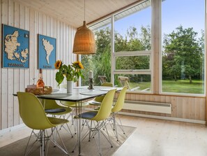 Enjoy meals in this dining area with a garden view, featuring a table and six chairs.