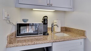 A kitchenette with a microwave, coffee maker, and sink. - Refreshing Escape B | Studio Legacy Villa (La Quinta)