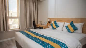Deluxe Room | 1 bedroom, desk, blackout curtains, iron/ironing board