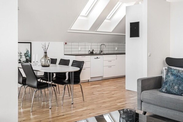 Enjoy meals at the dining table and relax on the sofa in this stylish apartment.