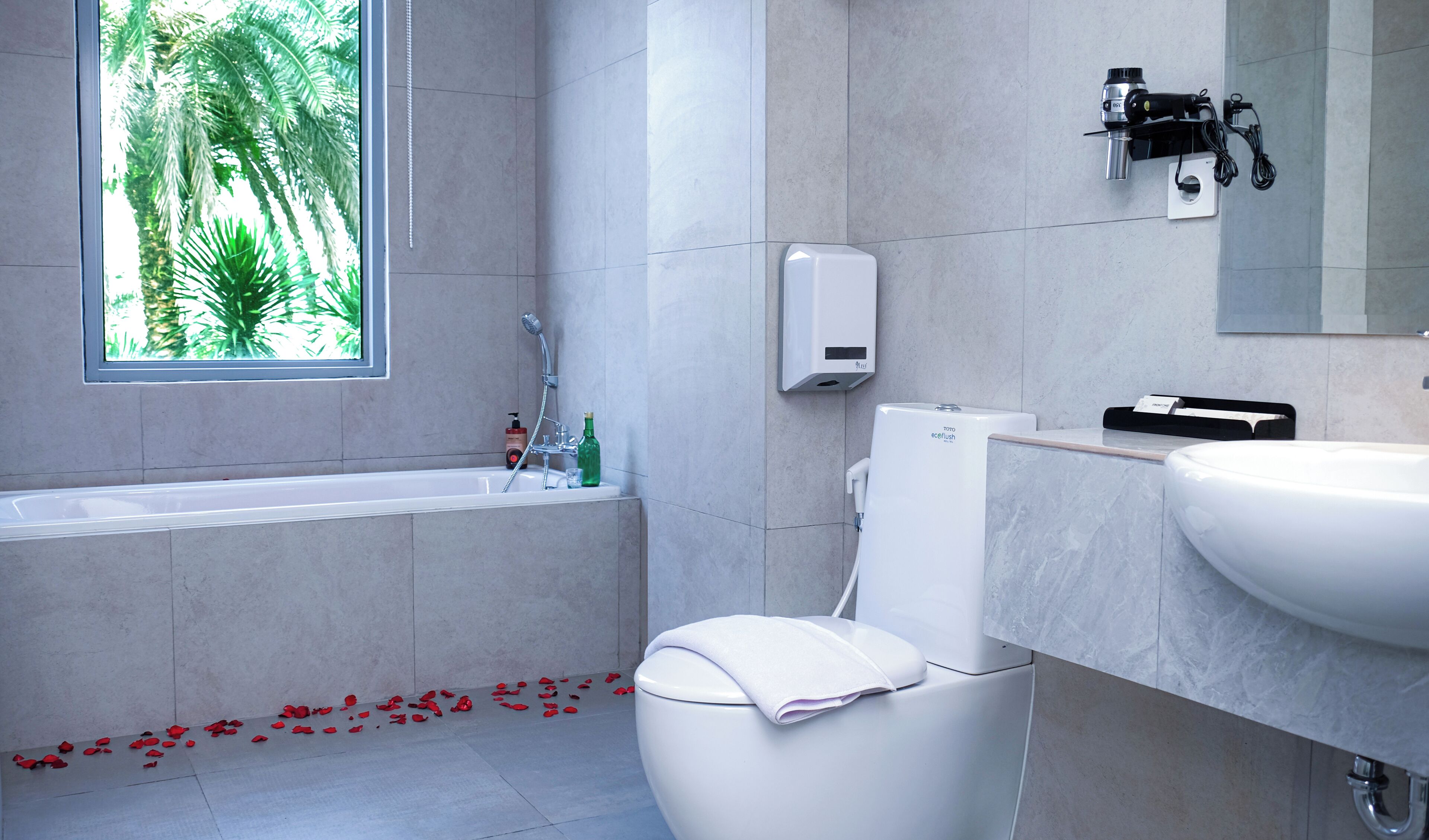 A modern bathroom with a bathtub, toilet, and sink.