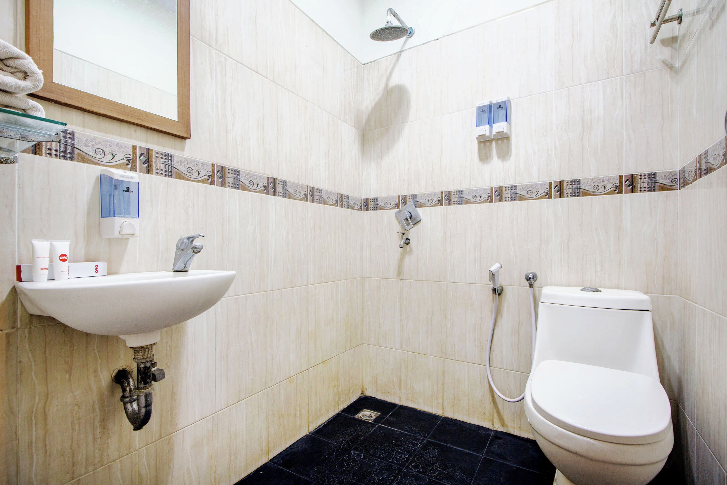 A bathroom with a sink, toilet, and shower.
