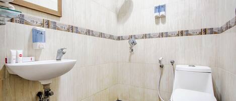 A bathroom with a sink, toilet, and shower.