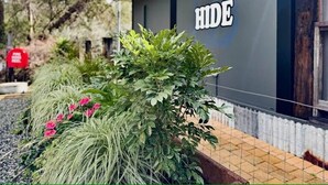 A building with a sign reading "THE HIDE" on the side. - The Hide, Rustic charm meets coastal calm. (Bouvard)