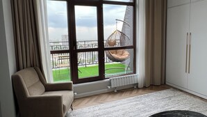 Una sala de estar moderna con un ventanal grande, un sillón colgante y un diseño minimalista.