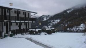 Ein Gebäude vor einer verschneiten Landschaft.