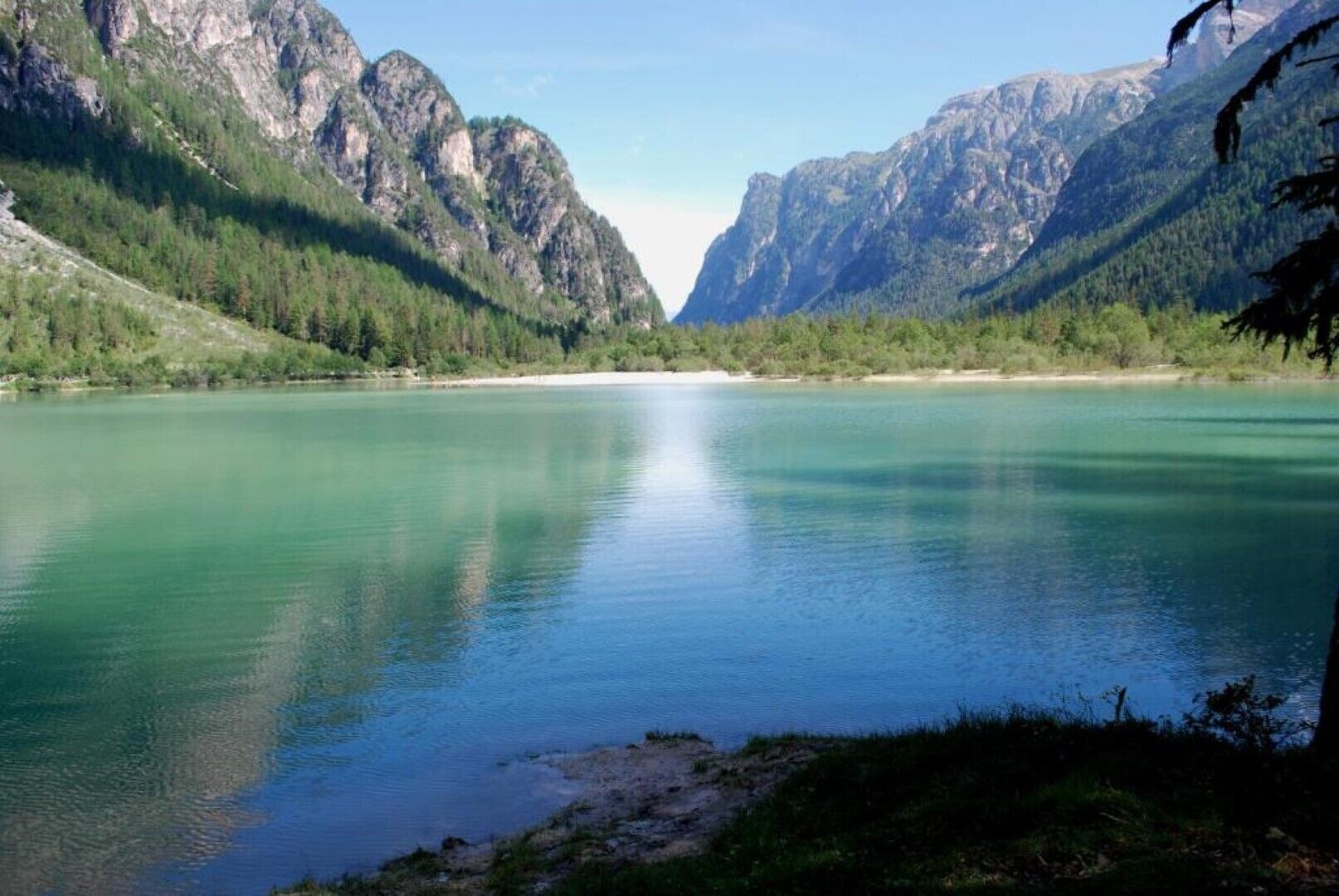 A serene lake surrounded by mountains.