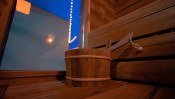 A wooden bucket on a bench with a window view.