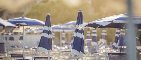 Private beach, white sand, sun loungers, beach umbrellas