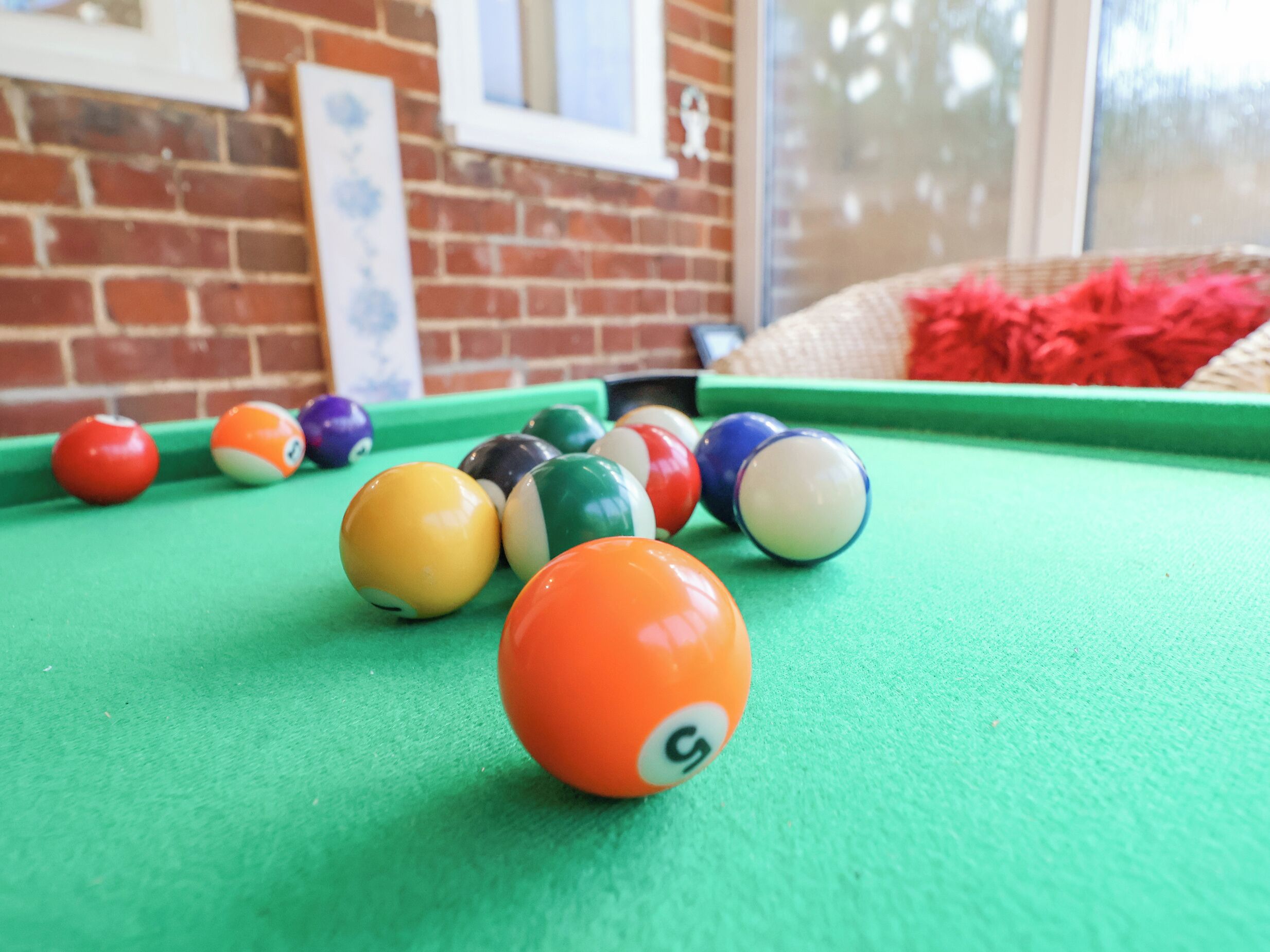 A pool table with various colored balls.