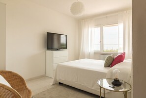 Cozy retreat with a comfortable bed, TV, and a small table for relaxation.