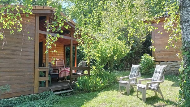 A wooden cabin with a porch and outdoor seating area. - QUAZEMI chalets in Casteil vacation rentals (Casteil)