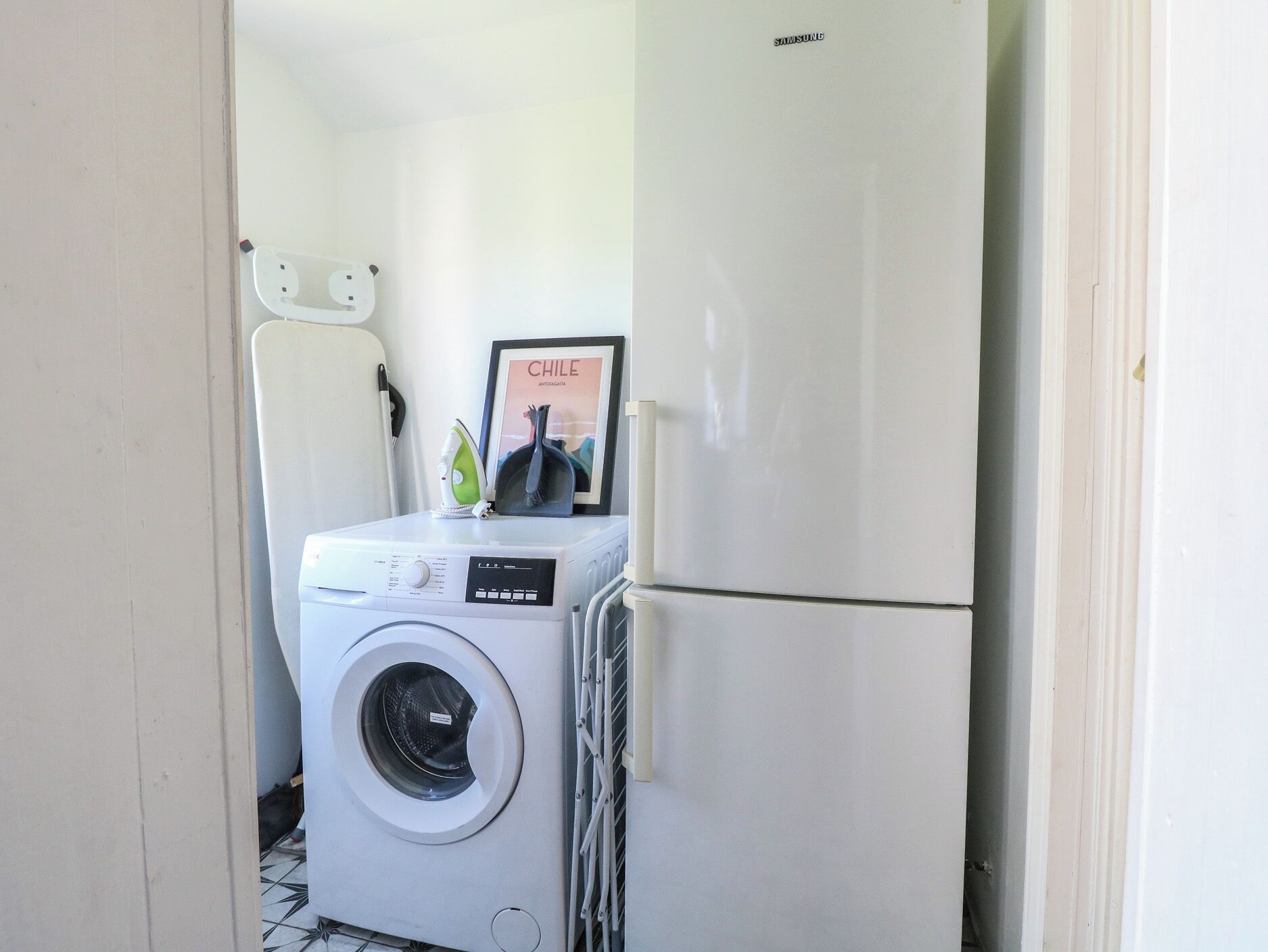 A compact laundry area with a washing machine, a dryer, and a refrigerator.