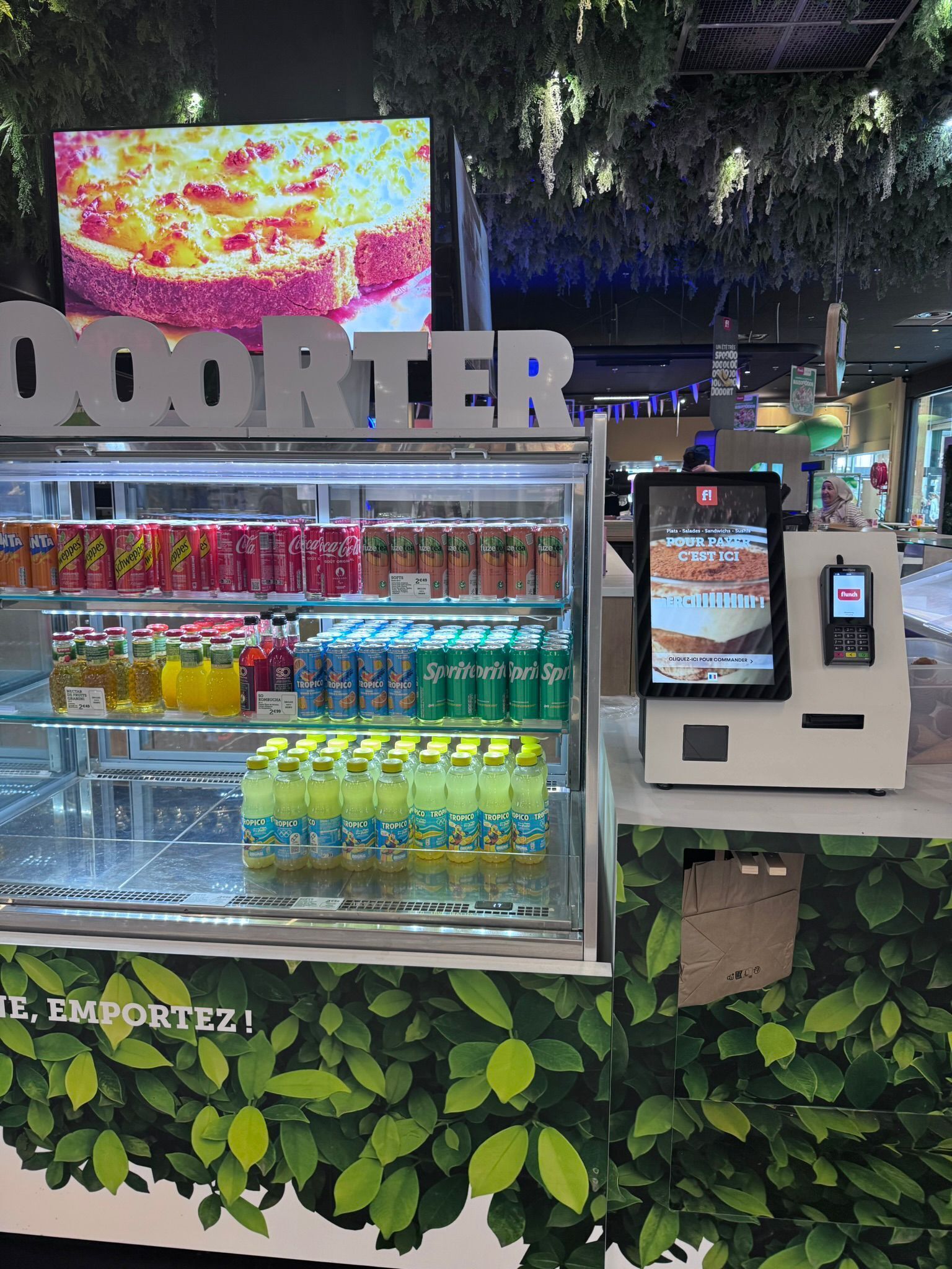 A vending machine with a digital display and a selection of beverages.