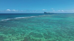 A clear view of a coastal area with turquoise waters and a distant island. - Pointe d'Azur by Horizon Holidays (Grand-Baie)