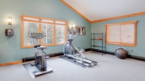 A home gym with two stationary bikes, a yoga mat, a kettlebell, and a large exercise ball. - Updated 1st Floor End Unit Near Main Street (Frisco)