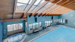 An indoor swimming pool with a wooden ceiling and large windows. - Updated 1st Floor End Unit Near Main Street (Frisco)