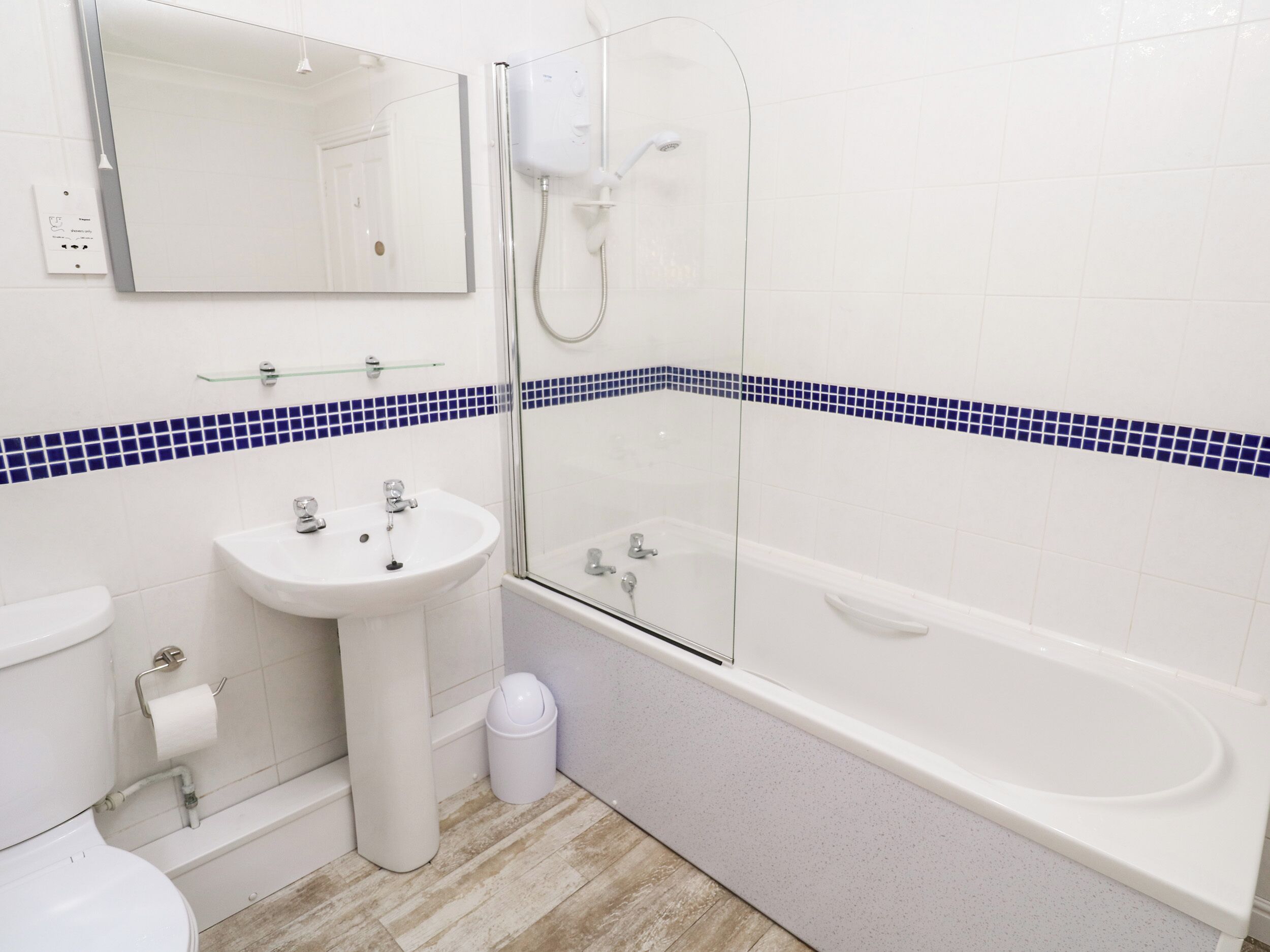 A bathroom with a sink, toilet, and bathtub.