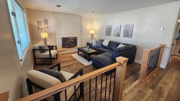 A spacious living room with a fireplace, a sofa set, and a coffee table. - Beautifully Updated Home on Oak Trail Drive in IF
 (Idaho Falls)