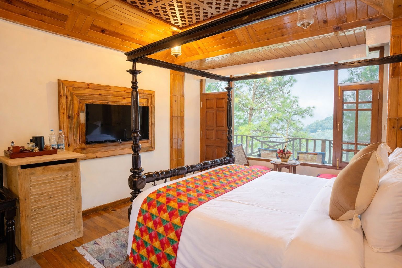 A bedroom with a four-poster bed, wooden ceiling, and a view of trees through a window.
