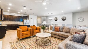 A modern living room with a sofa, armchairs, and a coffee table.