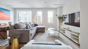A modern living room with a sofa, coffee table, and TV.