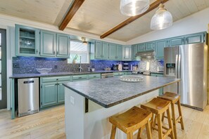 Enjoy cooking and socializing in this kitchen with a central island and bar stools.