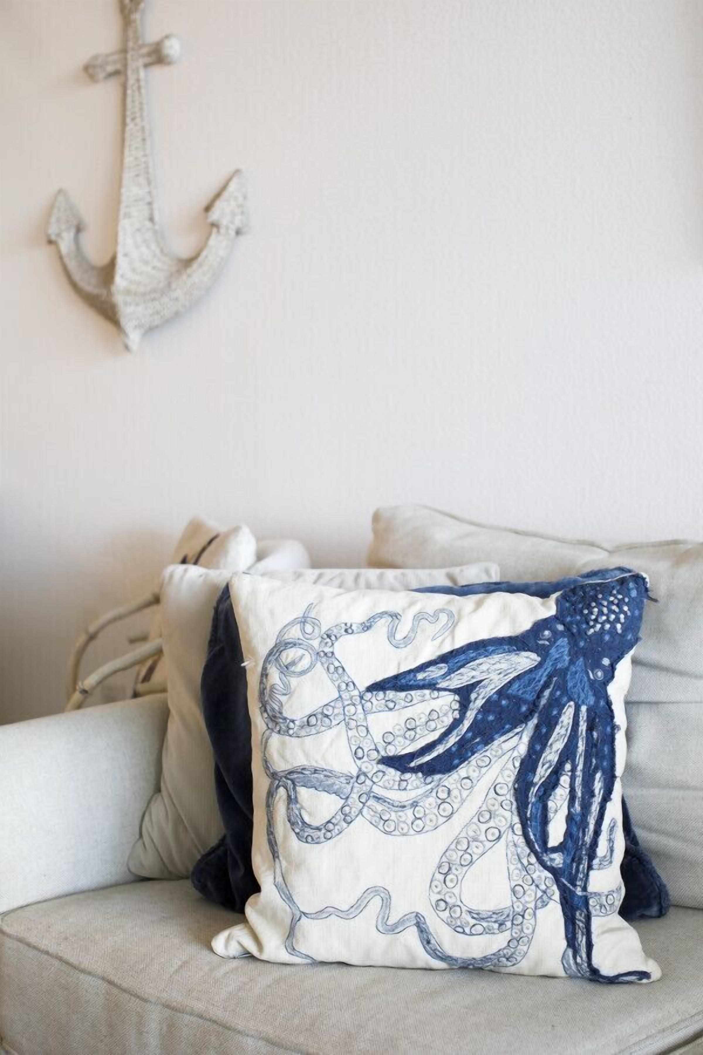 A sofa with a decorative pillow featuring an octopus design.