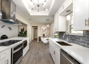 The kitchen is fully stocked with pots, pans, and all standard cooking tools.