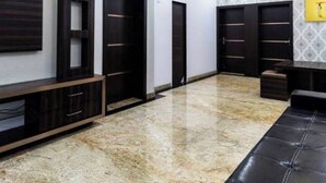 A spacious room with a ceiling fan, recessed lighting, a marble floor, and built-in wardrobes. - Raj Sea Front Beach Resort 102 (Mangaluru)