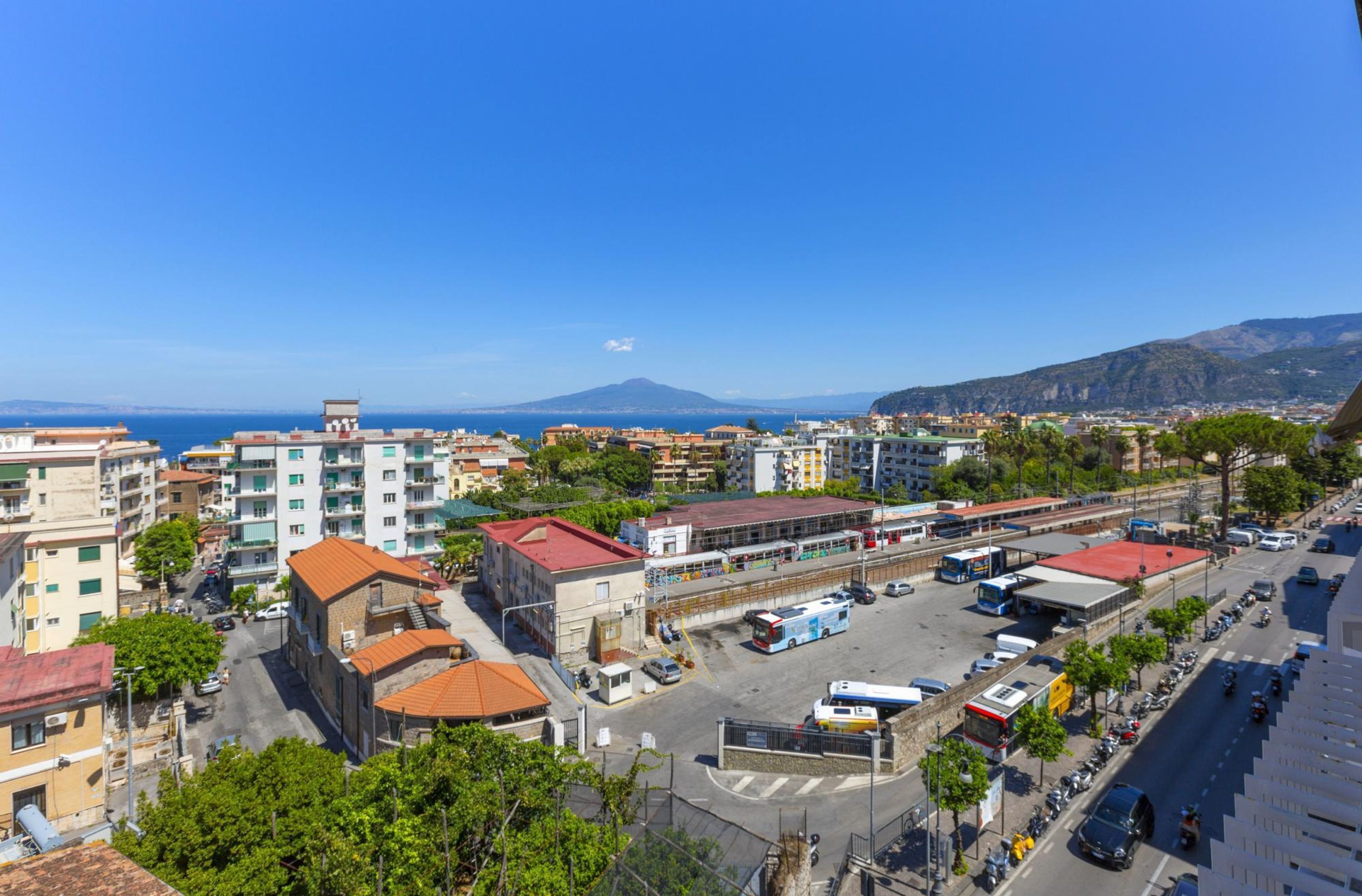 A cityscape with buildings, roads, and a mountain in the background.