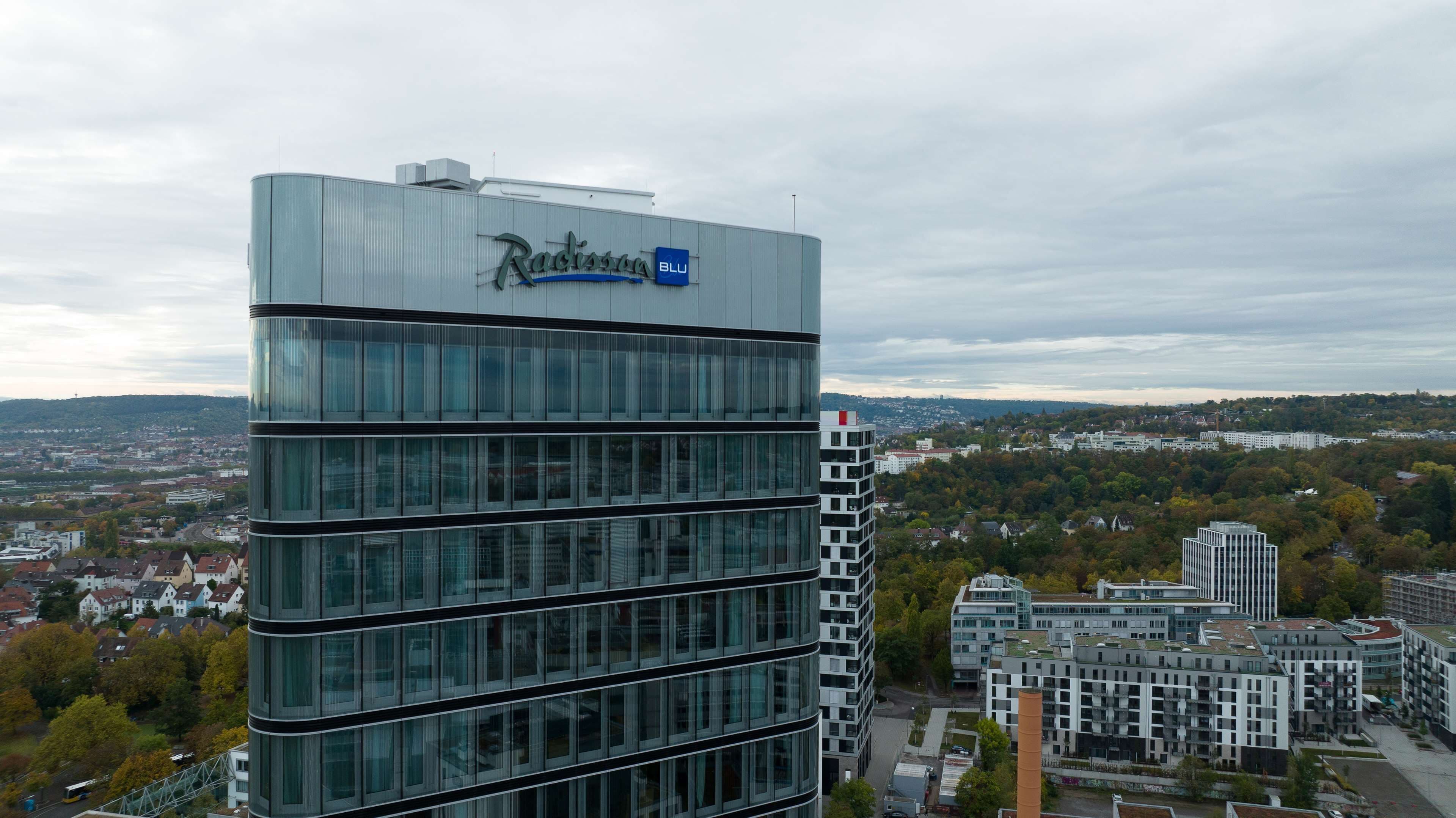 A modern building with a glass facade and the name "Radisson Blu" on the top.