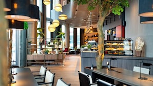 Un restaurant moderne doté d’un long comptoir, de plusieurs espaces de restauration et d’un bar.