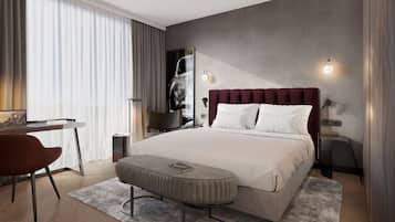 Ein modernes Hotelzimmer mit einem großen Bett, einem Schreibtisch und einem Sessel.