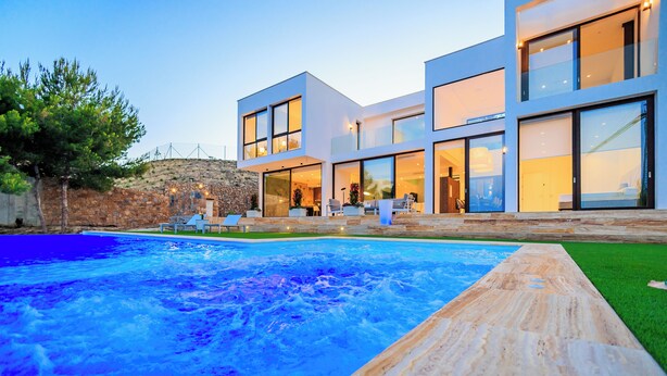 A modern house with a swimming pool, outdoor seating, and a stone wall. - Villa Martin Stone Las Colinas Golf Country Club (VC)