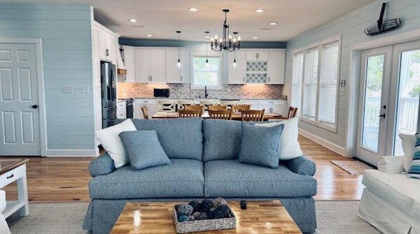 Relax in this stylish living space with a comfortable sofa and modern kitchen area.