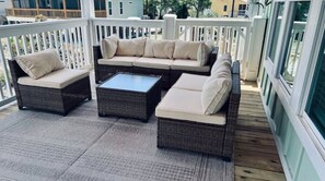 Relax in an outdoor seating area with a sectional sofa, armchairs, and coffee table.