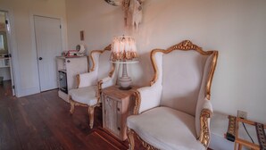 A room with two ornate chairs, a lamp, and a wall-mounted bull skull. - The Stardust Room - Wander Inn (Round Top)