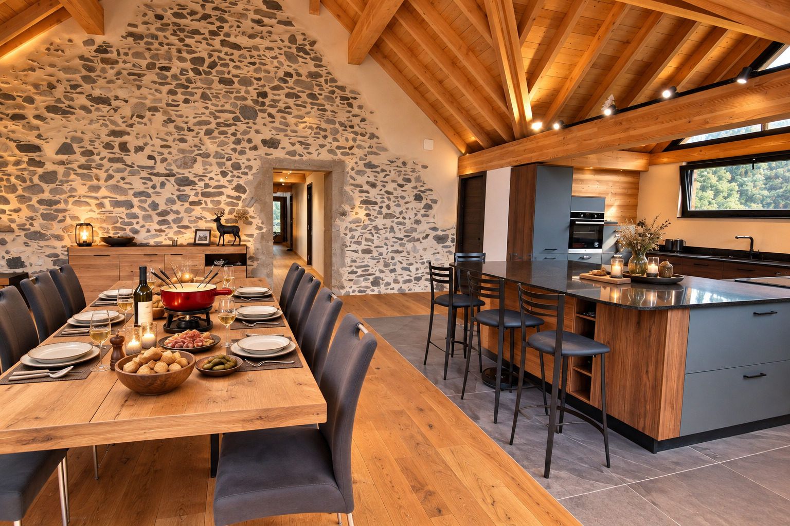 A dining area with a stone wall, wooden ceiling beams, and a modern kitchen with a large island.