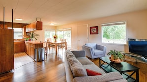 A modern living space with a kitchen, dining area, and seating area.