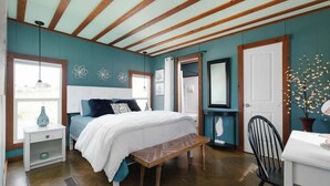 A bedroom with a bed, bedside tables, a bench, a chair, and a dresser. - 3BR Sleep 6 PALO DURO CANYON Bunker Cabin Pet OK (Canyon)